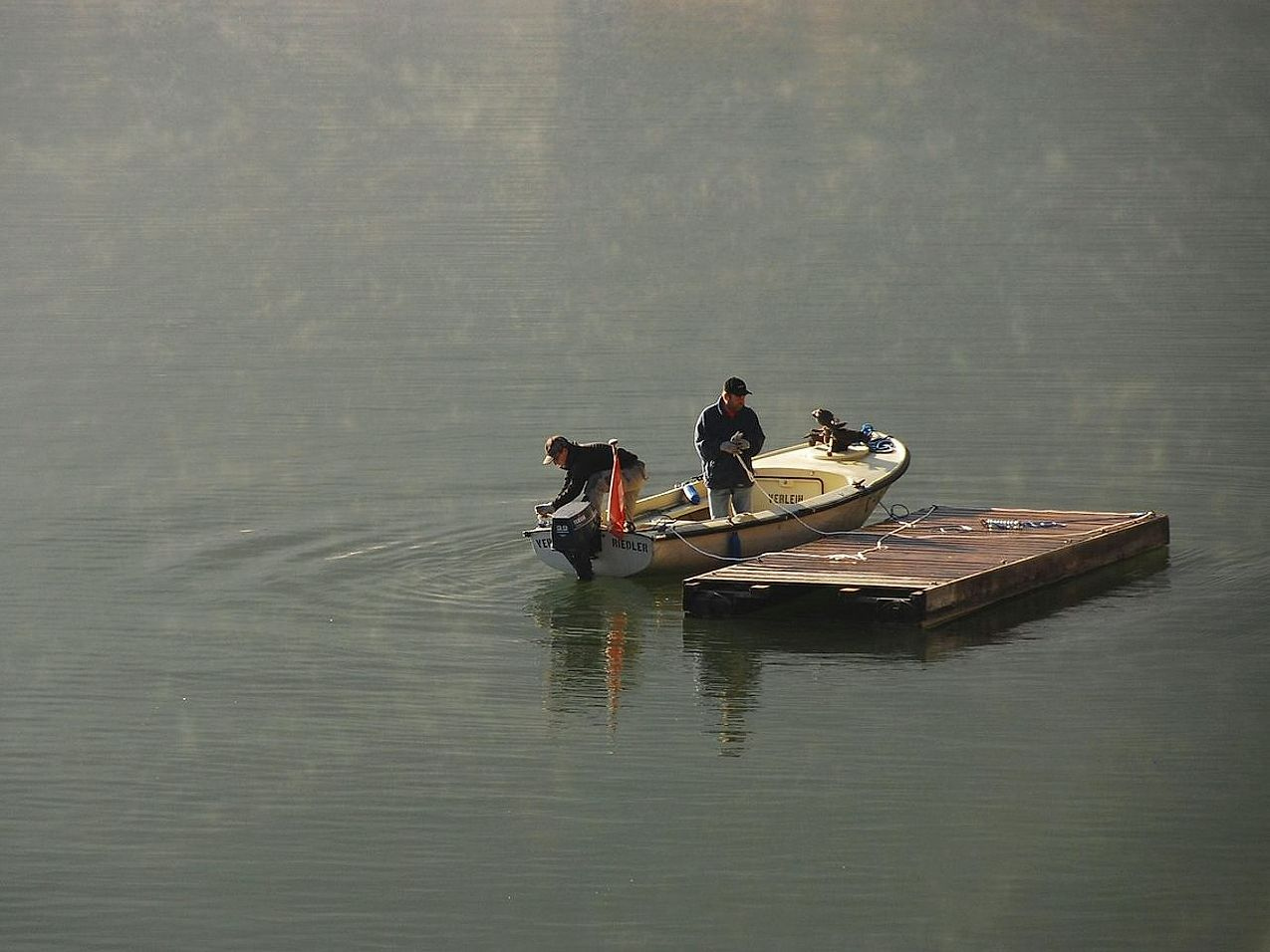 Angler casting from a grassy bank